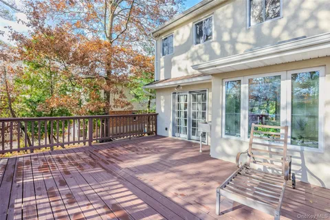 a view of a house with backyard and wooden fence