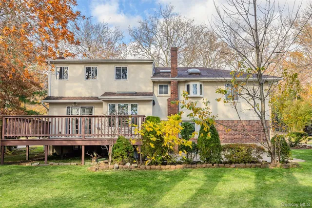 a view of a house with wooden floor next to a yard
