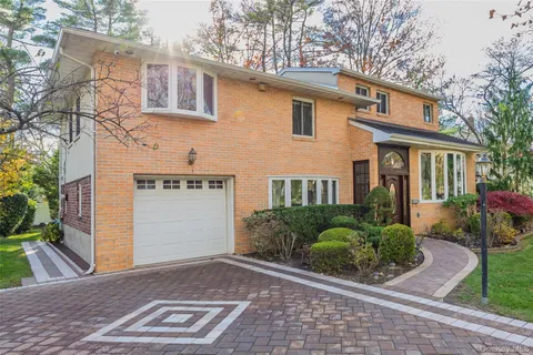 a view of a house with a yard and potted plants