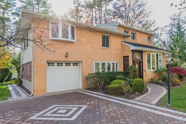 a view of a house with a yard and potted plants