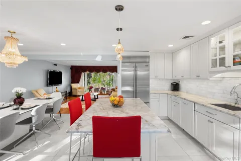 a kitchen with stainless steel appliances granite countertop a stove and white cabinets