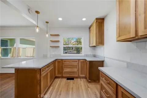 a kitchen with a sink and wooden floor
