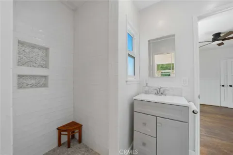 a bathroom with a sink a toilet and mirror