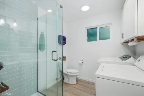 a bathroom with a shower a toilet and sink