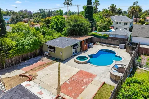 an aerial view of a house with swimming pool and outdoor seating