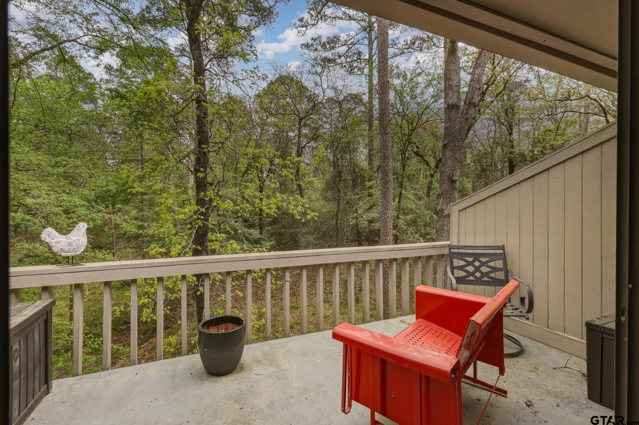 178 Holly Hill Circle Holly Lake Ranch, TX 75765 - Photo 12 of 18 a view of a chair and table on the balcony