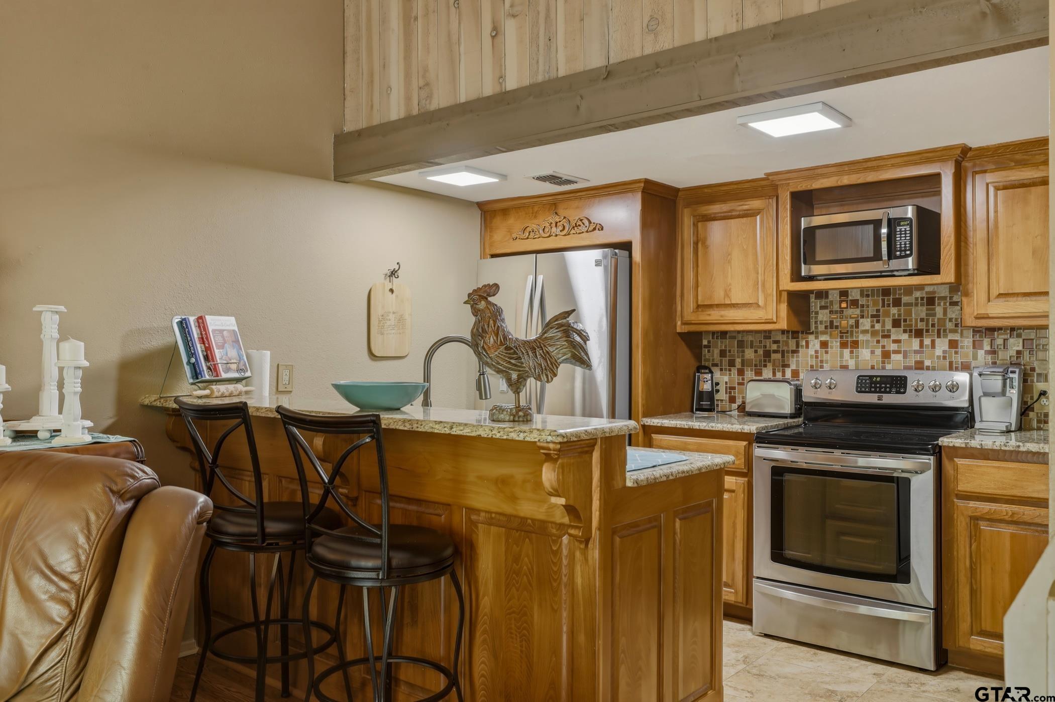 178 Holly Hill Circle Holly Lake Ranch, TX 75765 - Photo 13 of 18 a view of a kitchen with a sink cabinets and stainless steel appliances