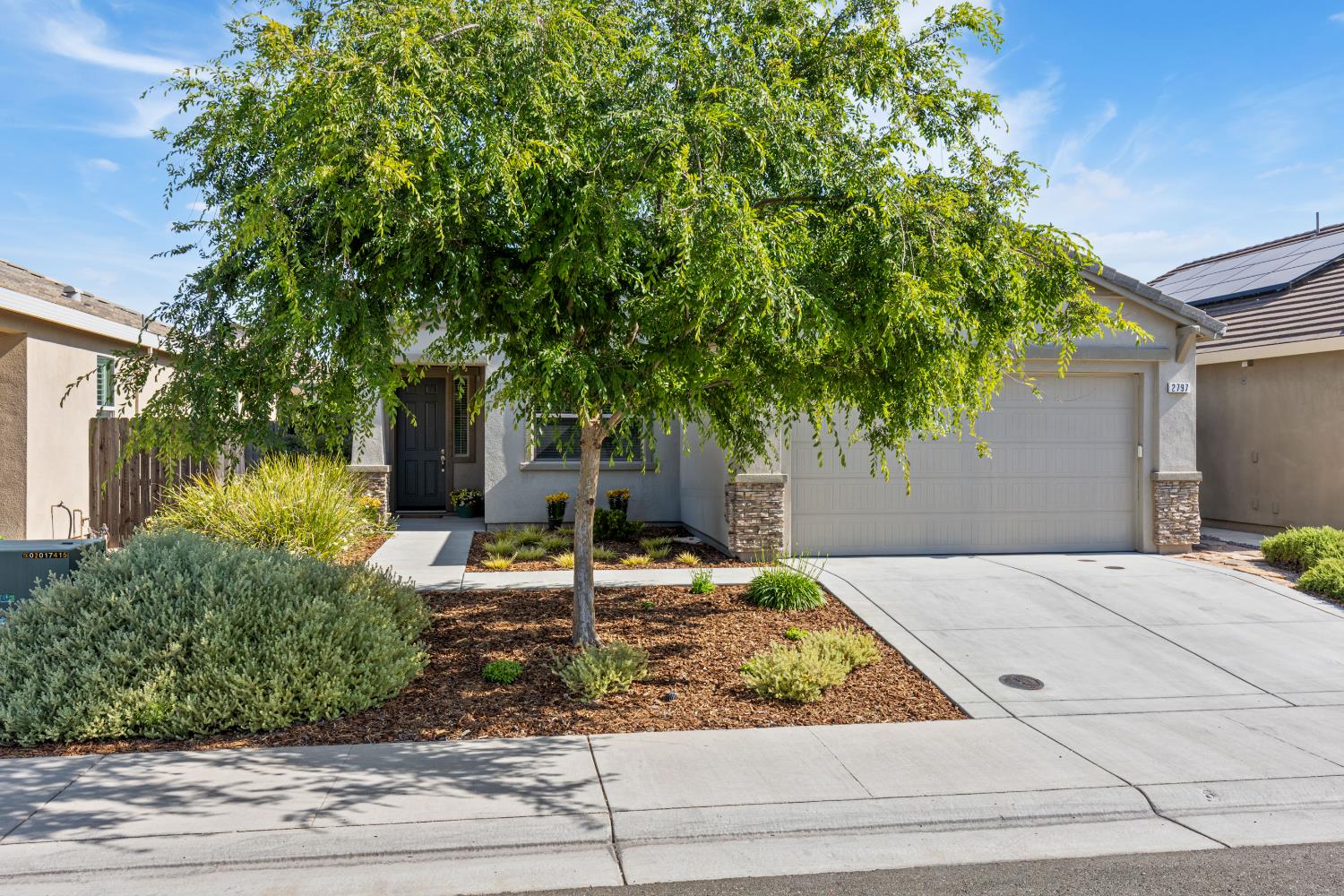 a front view of a house with garden