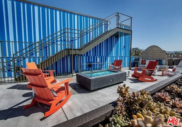 a backyard of a house with outdoor seating