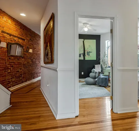a hallway with a couch and wooden floor