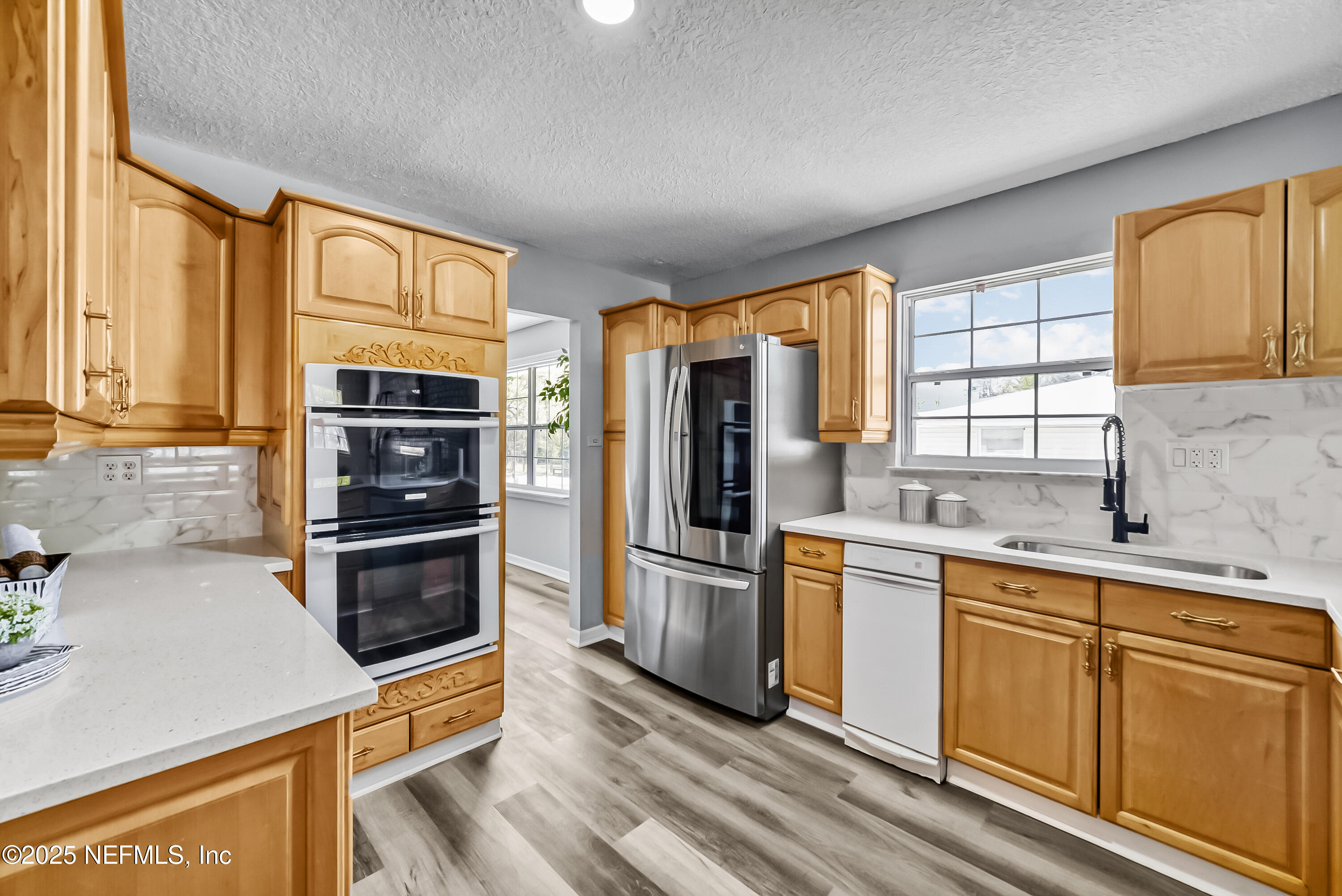 11084 Ker Del Road Jacksonville, FL 32218 - Photo 11 of 26 a kitchen with stainless steel appliances a stove sink and refrigerator