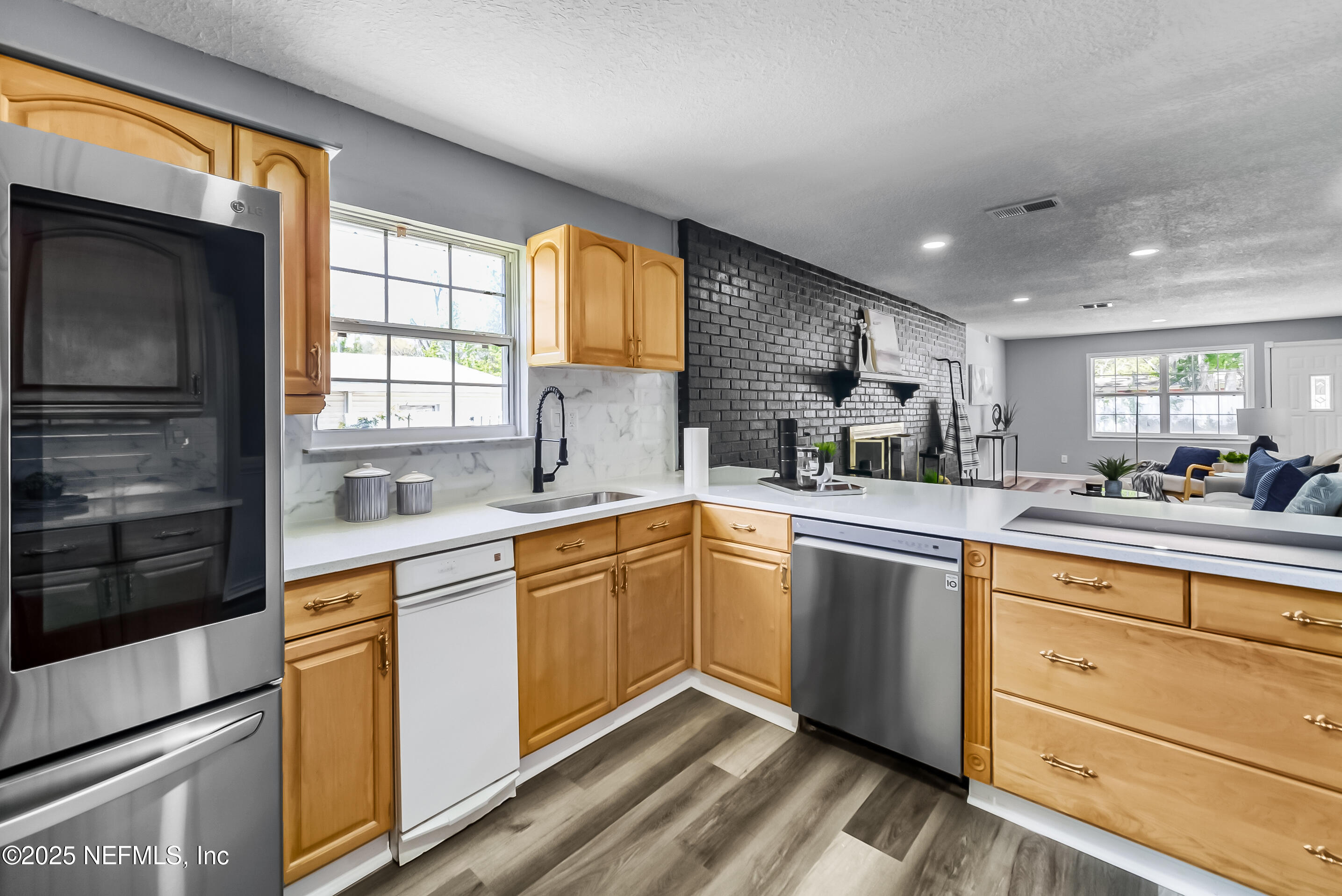 11084 Ker Del Road Jacksonville, FL 32218 - Photo 12 of 26 a kitchen with cabinets a sink and appliances