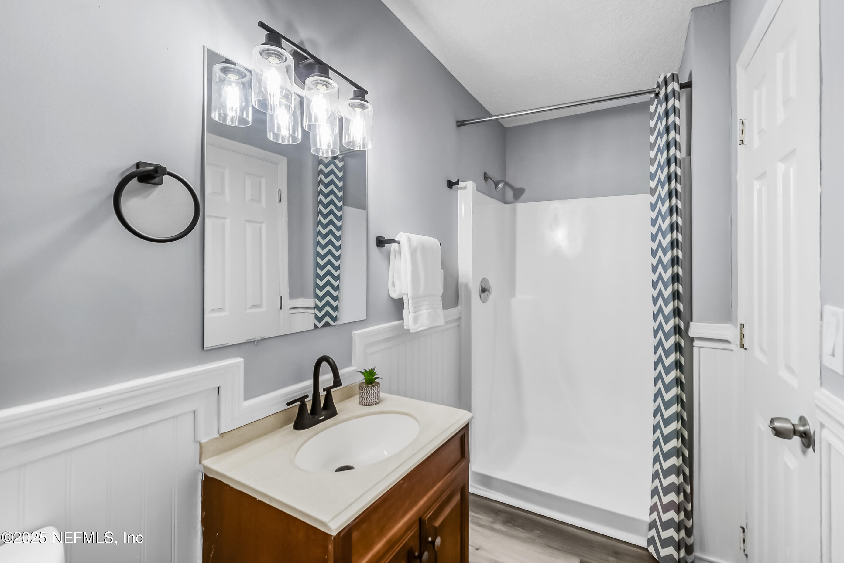11084 Ker Del Road Jacksonville, FL 32218 - Photo 15 of 26 a bathroom with a sink a mirror a vanity and a shower