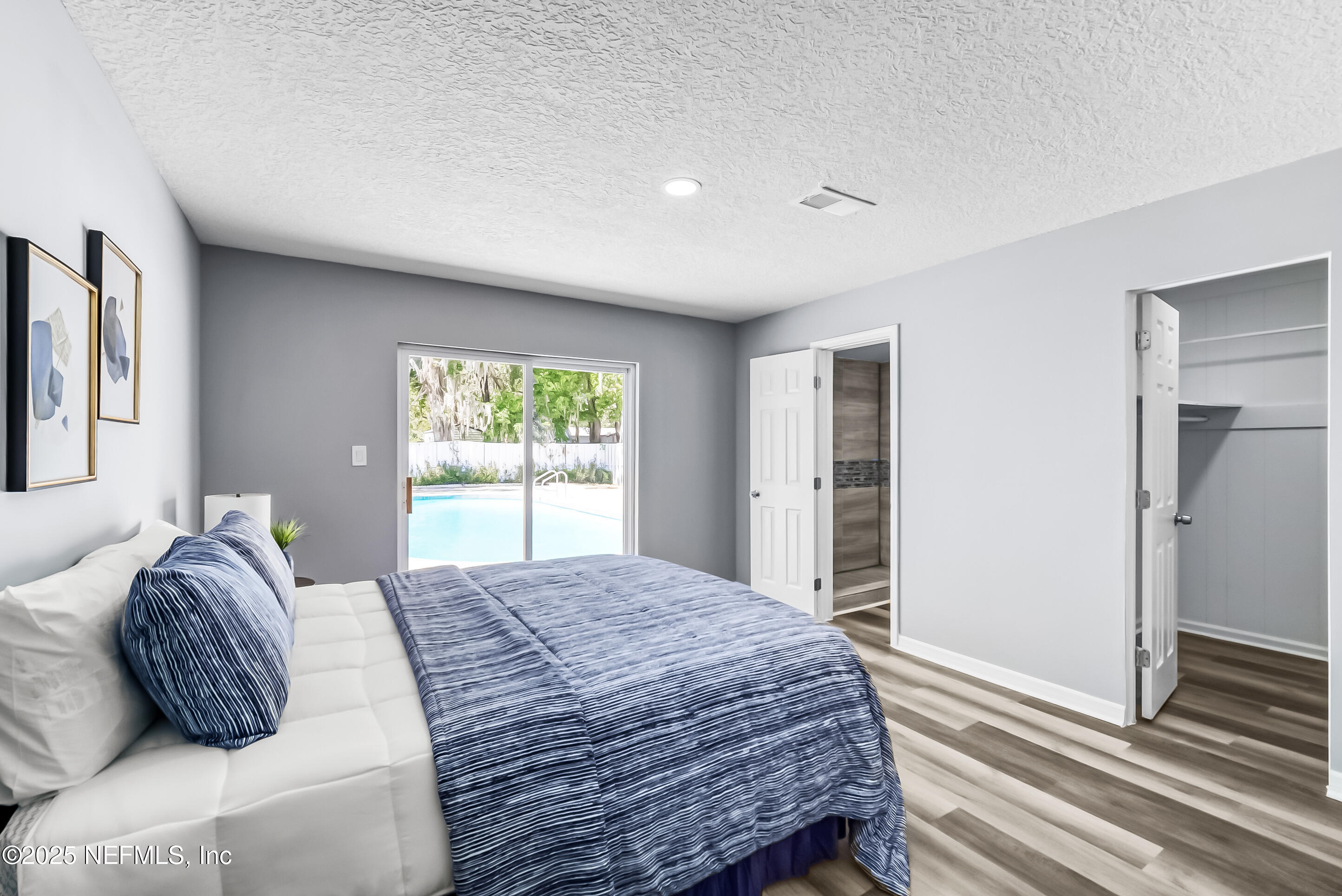 11084 Ker Del Road Jacksonville, FL 32218 - Photo 16 of 26 a bedroom with a bed two windows and wooden floor