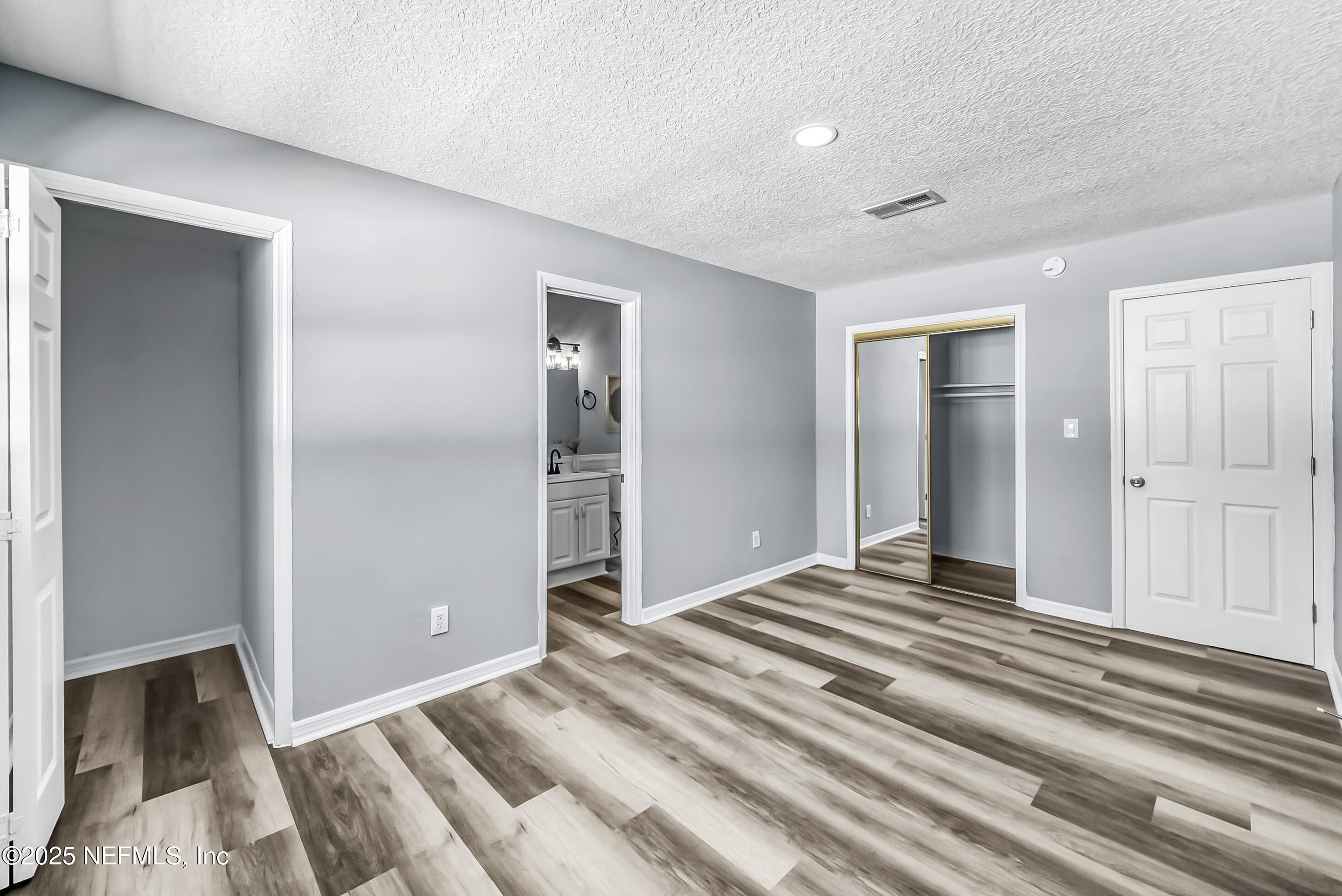 11084 Ker Del Road Jacksonville, FL 32218 - Photo 19 of 26 a view of a bedroom with wooden floor & bathroom