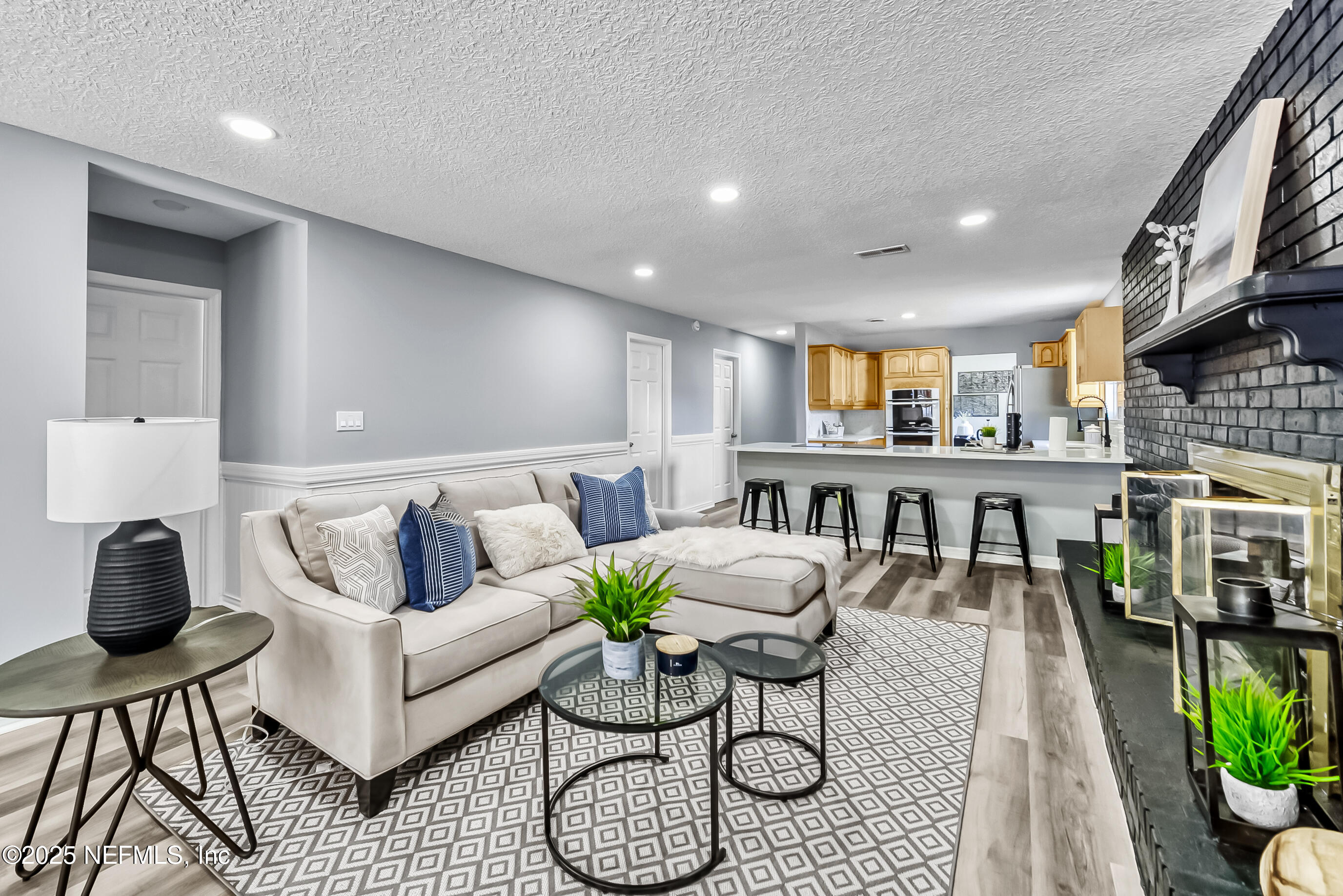 11084 Ker Del Road Jacksonville, FL 32218 - Photo 8 of 26 a living room with furniture a wooden floor and a potted plant