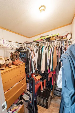 a view of walk in closet with clothes