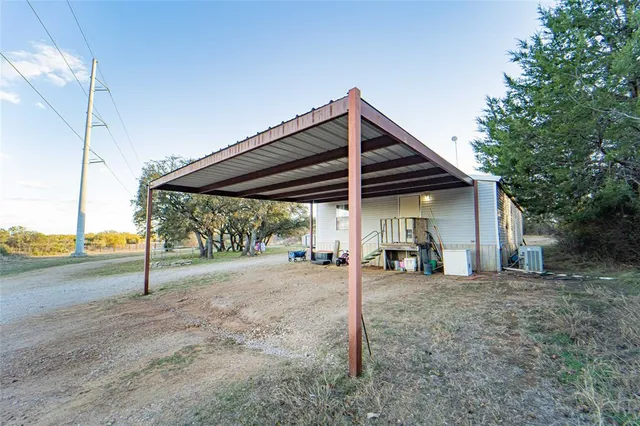 a view of a house with a porch and furniture