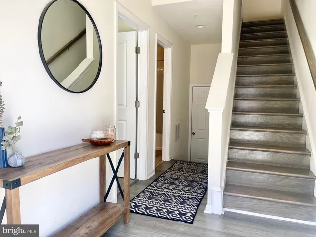a view of a hallway with wooden floor and entryway