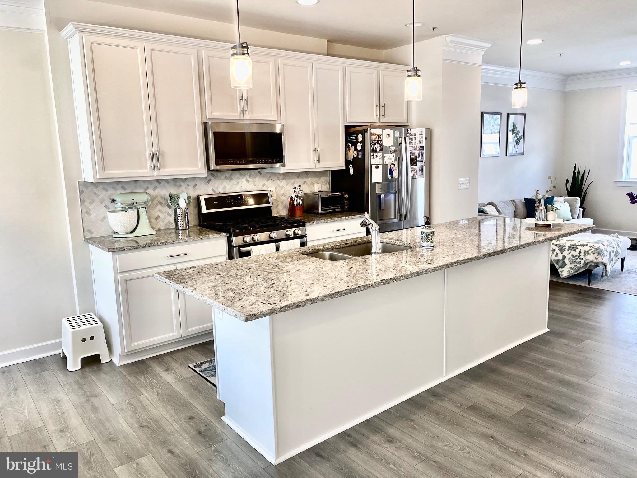 14327 Summit View Lane Rockville, MD 20850 - Photo 3 of 21 a kitchen with stainless steel appliances granite countertop a sink a stove and a microwave