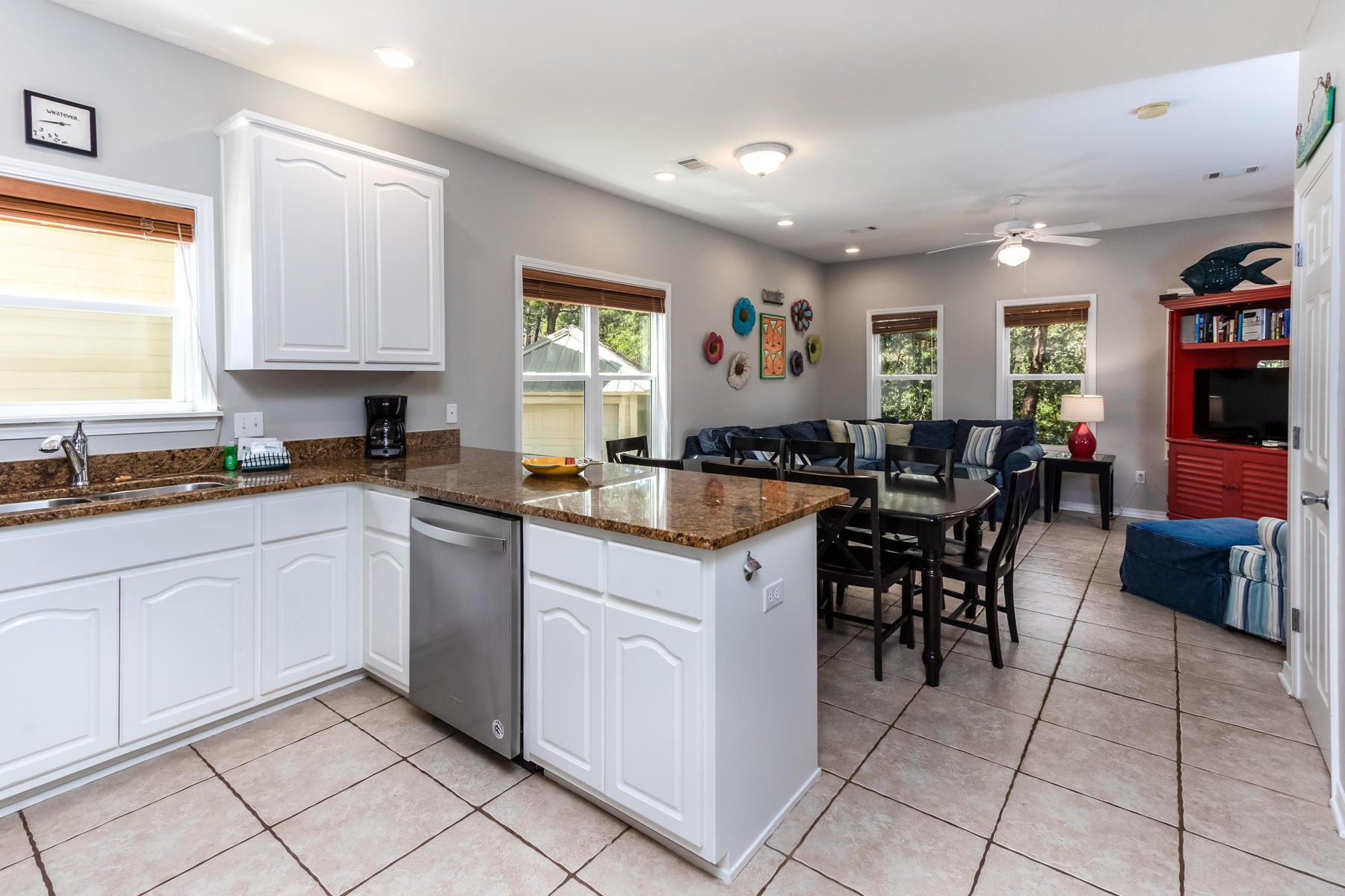 460 Hidden Lake Way Santa Rosa Beach, FL 32459 - Photo 21 of 40 a kitchen with granite countertop cabinets a dining table and a window