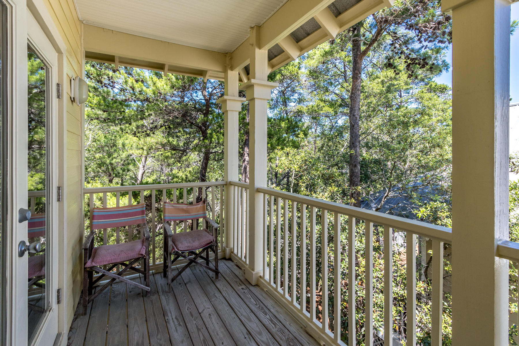 460 Hidden Lake Way Santa Rosa Beach, FL 32459 - Photo 10 of 40 a view of a balcony with chairs and wooden floor