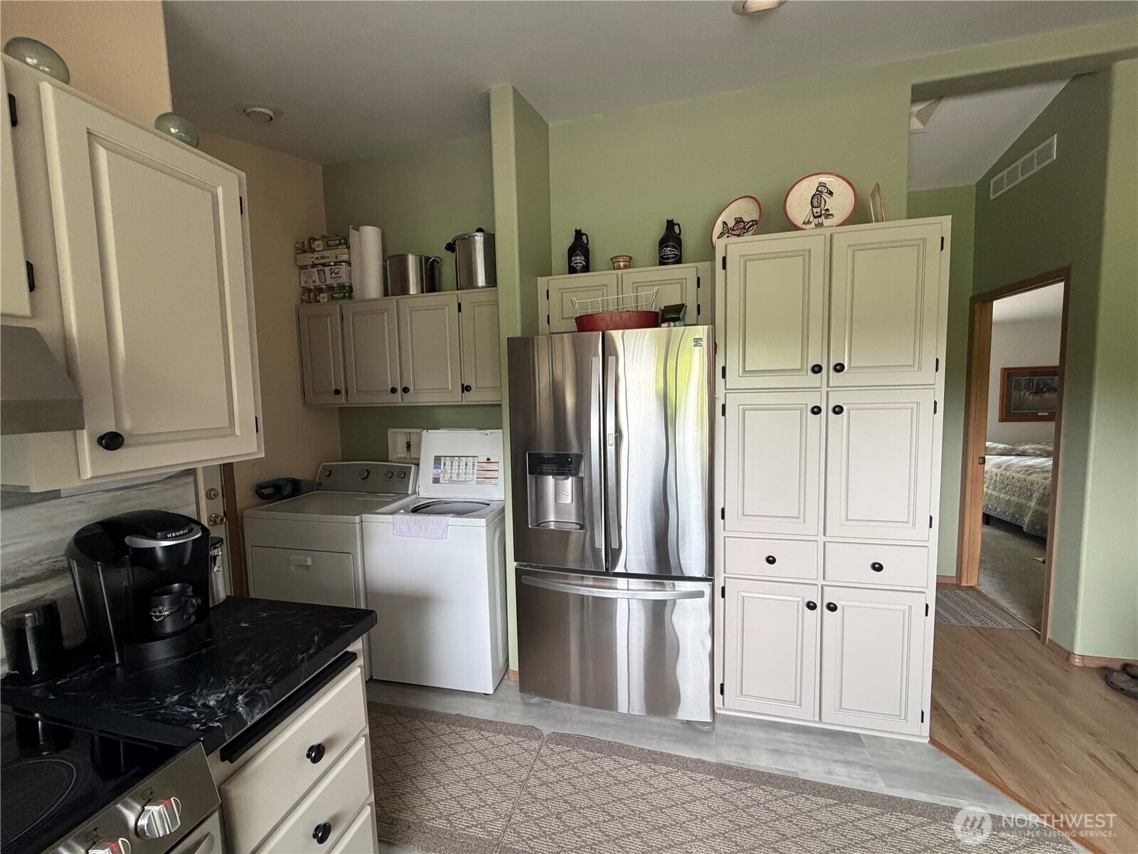 1171 Ray Hicks Street Raymond, WA 98577 - Photo 11 of 33 a kitchen with granite countertop a refrigerator stove and sink