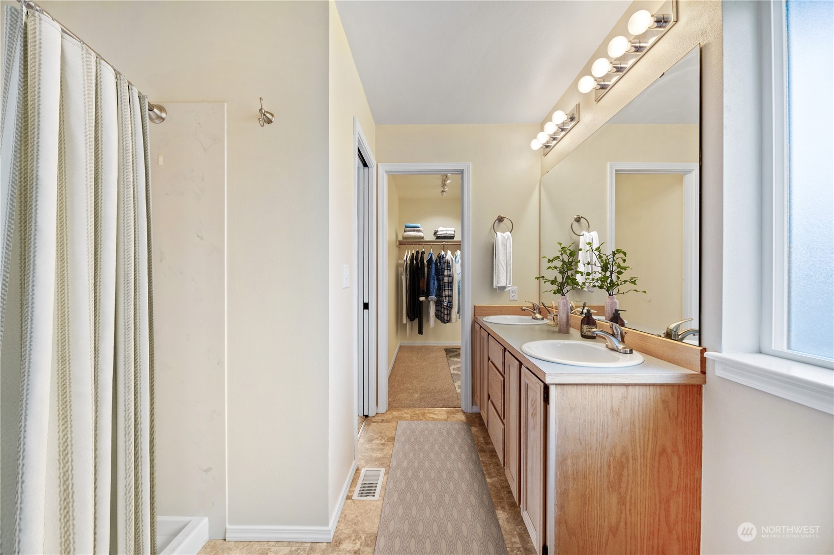 15014 Silver Firs Drive Everett, WA 98208 - Photo 17 of 30 a en suite bathroom with a sink and mirror with shower