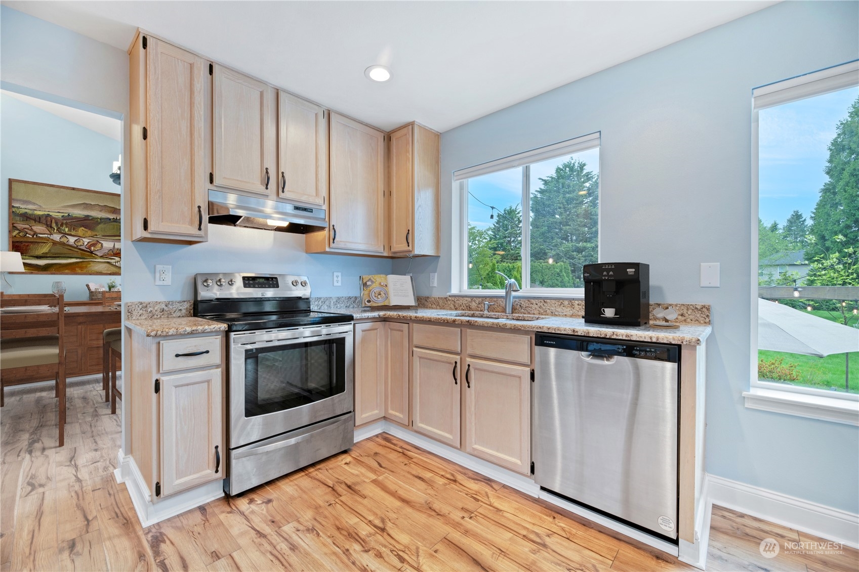 15014 Silver Firs Drive Everett, WA 98208 - Photo 7 of 30 a kitchen with stainless steel appliances white cabinets a sink and a stove