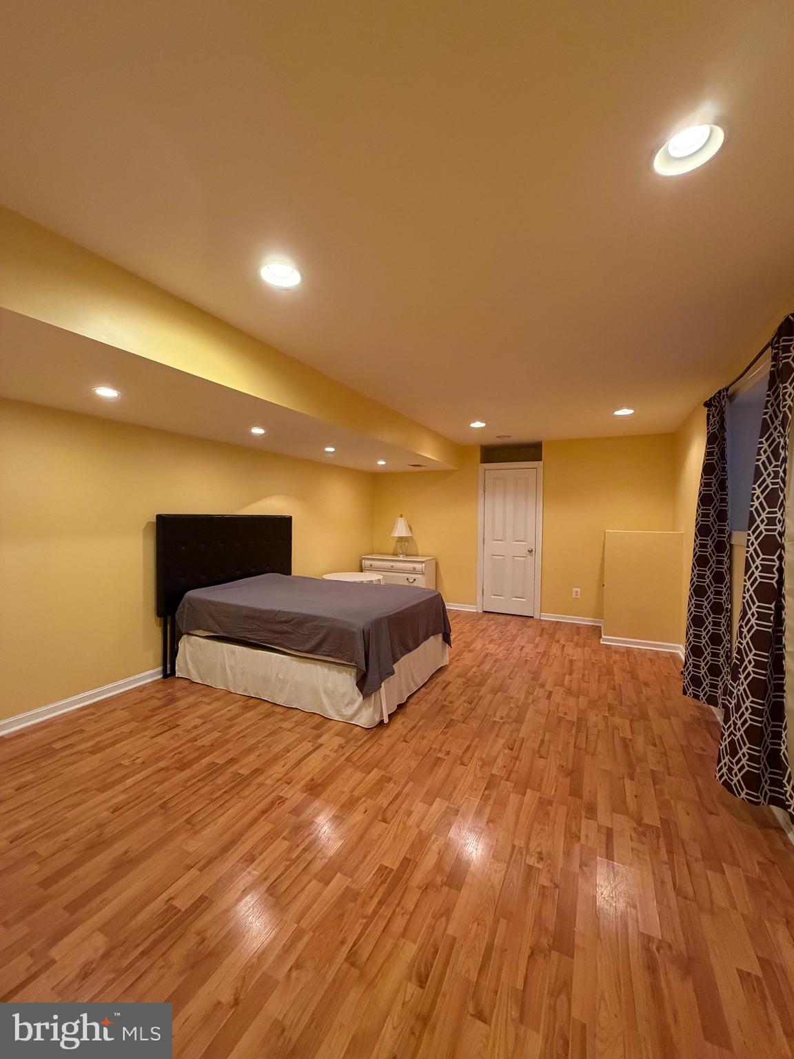8650 Trenton Chapel Way Manassas, VA 20109 - Photo 2 of 8 a spacious bedroom with a bed and a dresser