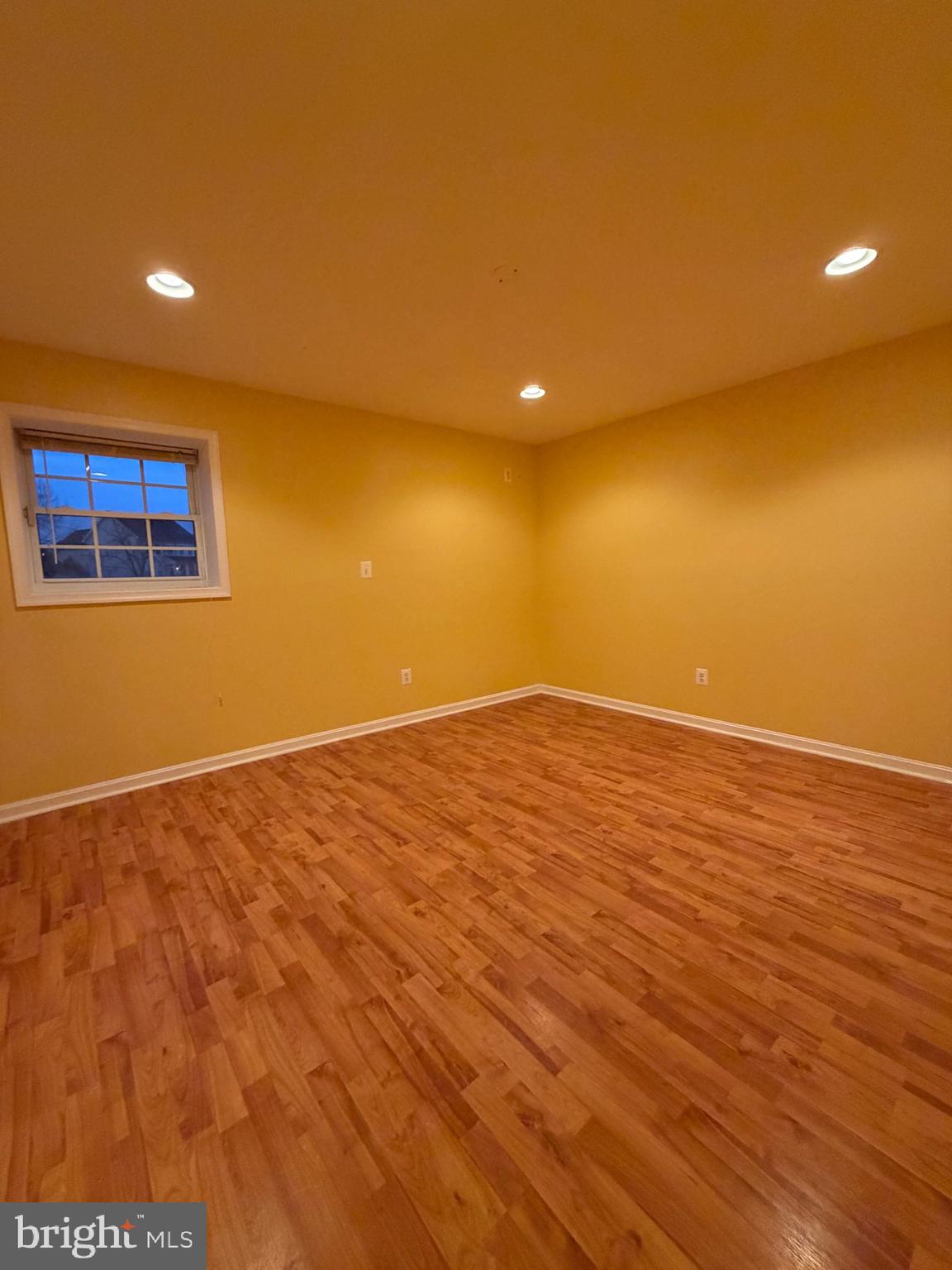8650 Trenton Chapel Way Manassas, VA 20109 - Photo 5 of 8 an empty room with wooden floor and windows