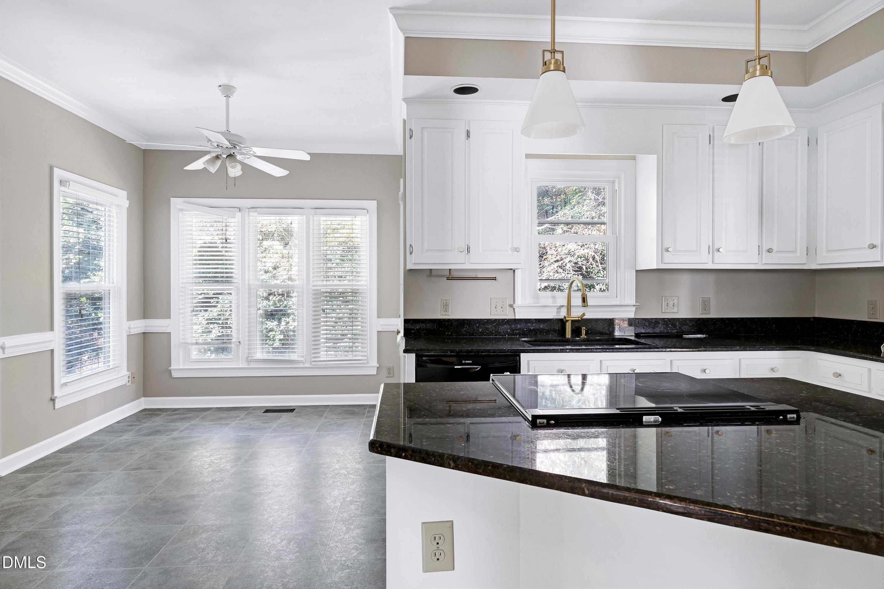 4804 Sinclair Drive Raleigh, NC 27616 - Photo 10 of 37 a kitchen with stainless steel appliances granite countertop a sink a stove and white cabinets