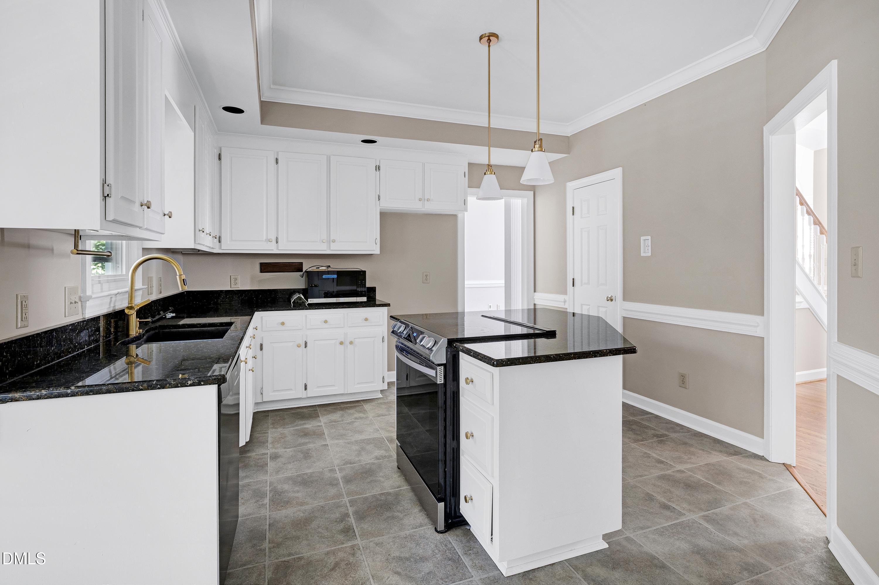 4804 Sinclair Drive Raleigh, NC 27616 - Photo 11 of 37 a kitchen with granite countertop a sink a stove and refrigerator