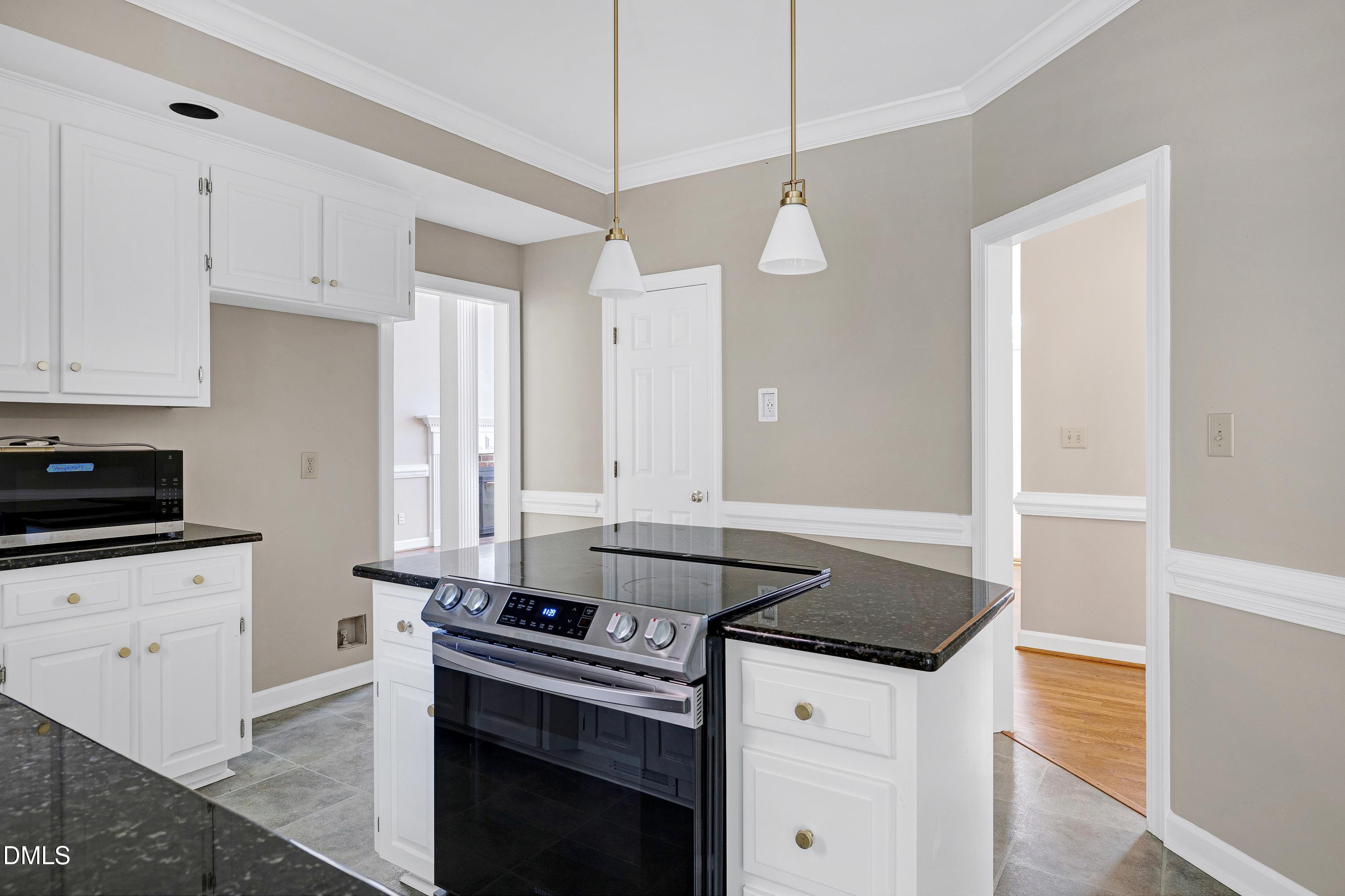 4804 Sinclair Drive Raleigh, NC 27616 - Photo 12 of 37 a kitchen with granite countertop a sink a stove and cabinets