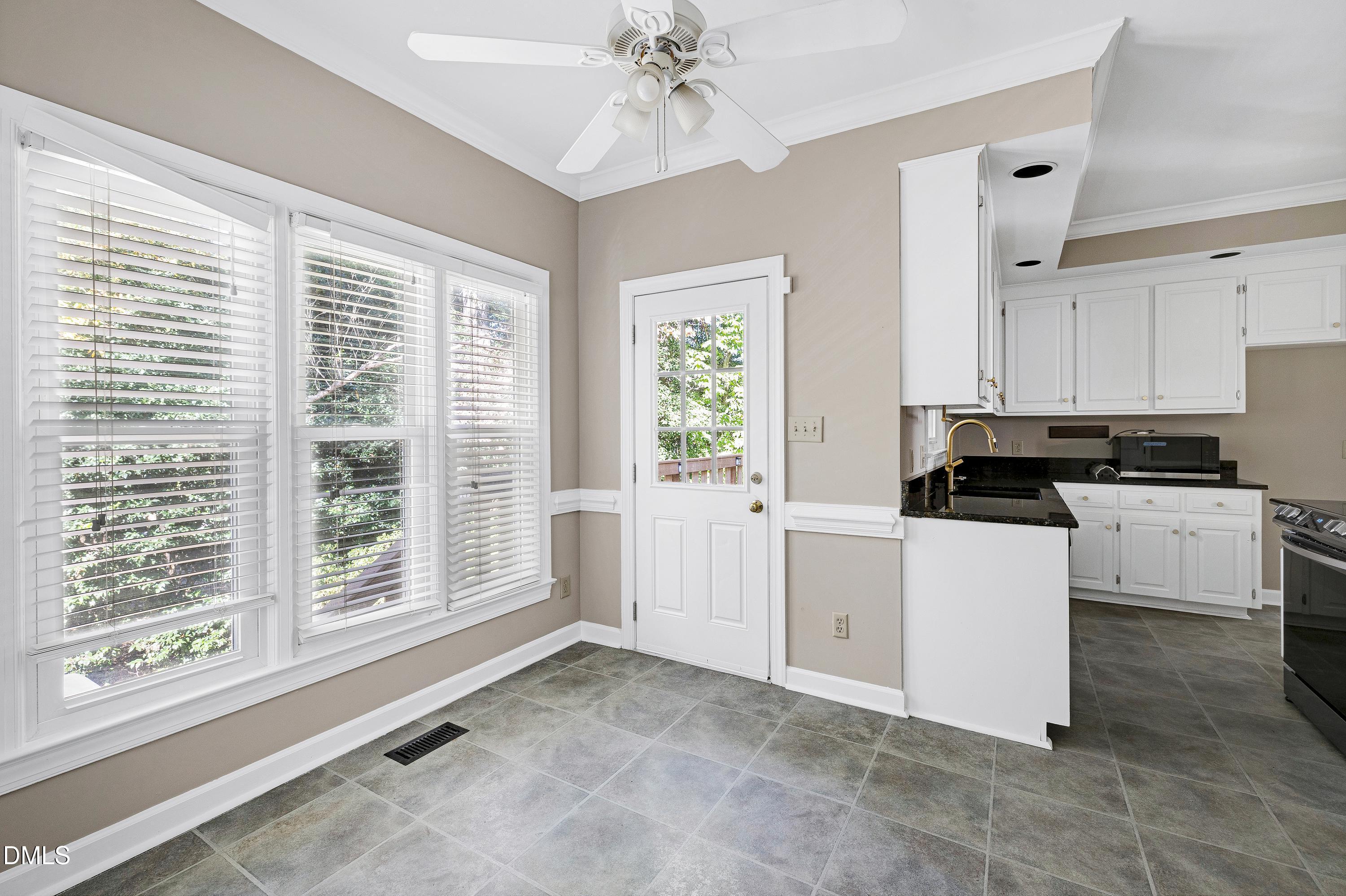 4804 Sinclair Drive Raleigh, NC 27616 - Photo 14 of 37 a kitchen with a refrigerator and a large window