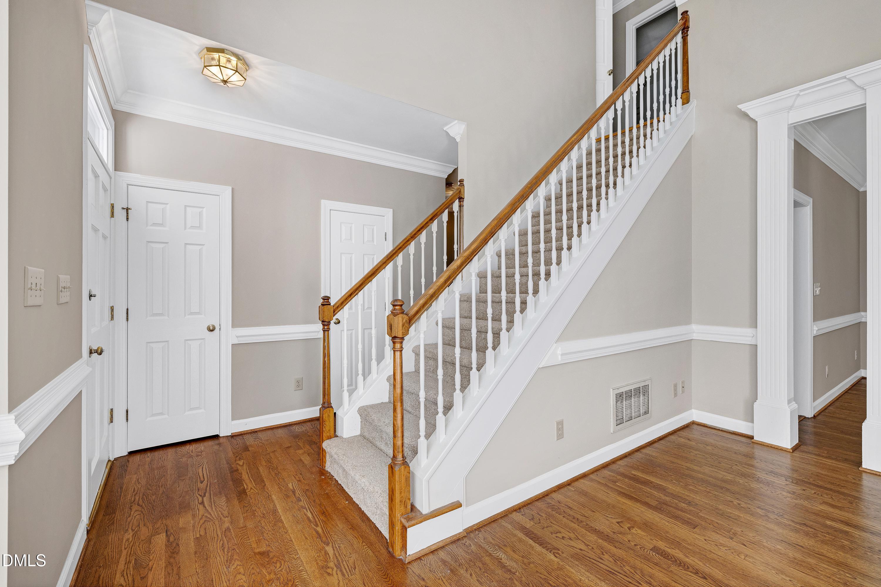 4804 Sinclair Drive Raleigh, NC 27616 - Photo 22 of 37 a view of front door with hallway and wooden floor