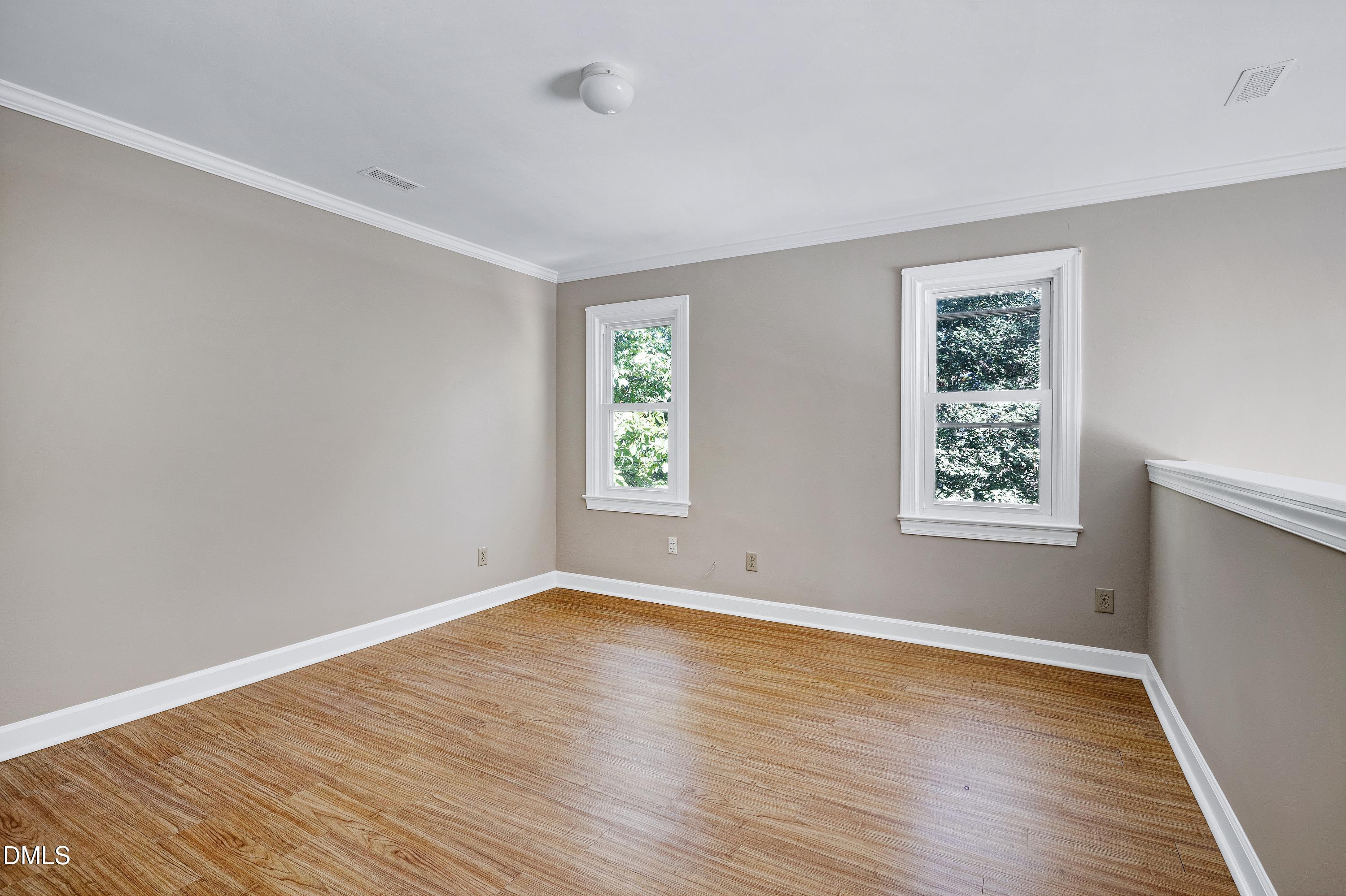 4804 Sinclair Drive Raleigh, NC 27616 - Photo 23 of 37 an empty room with wooden floor and windows