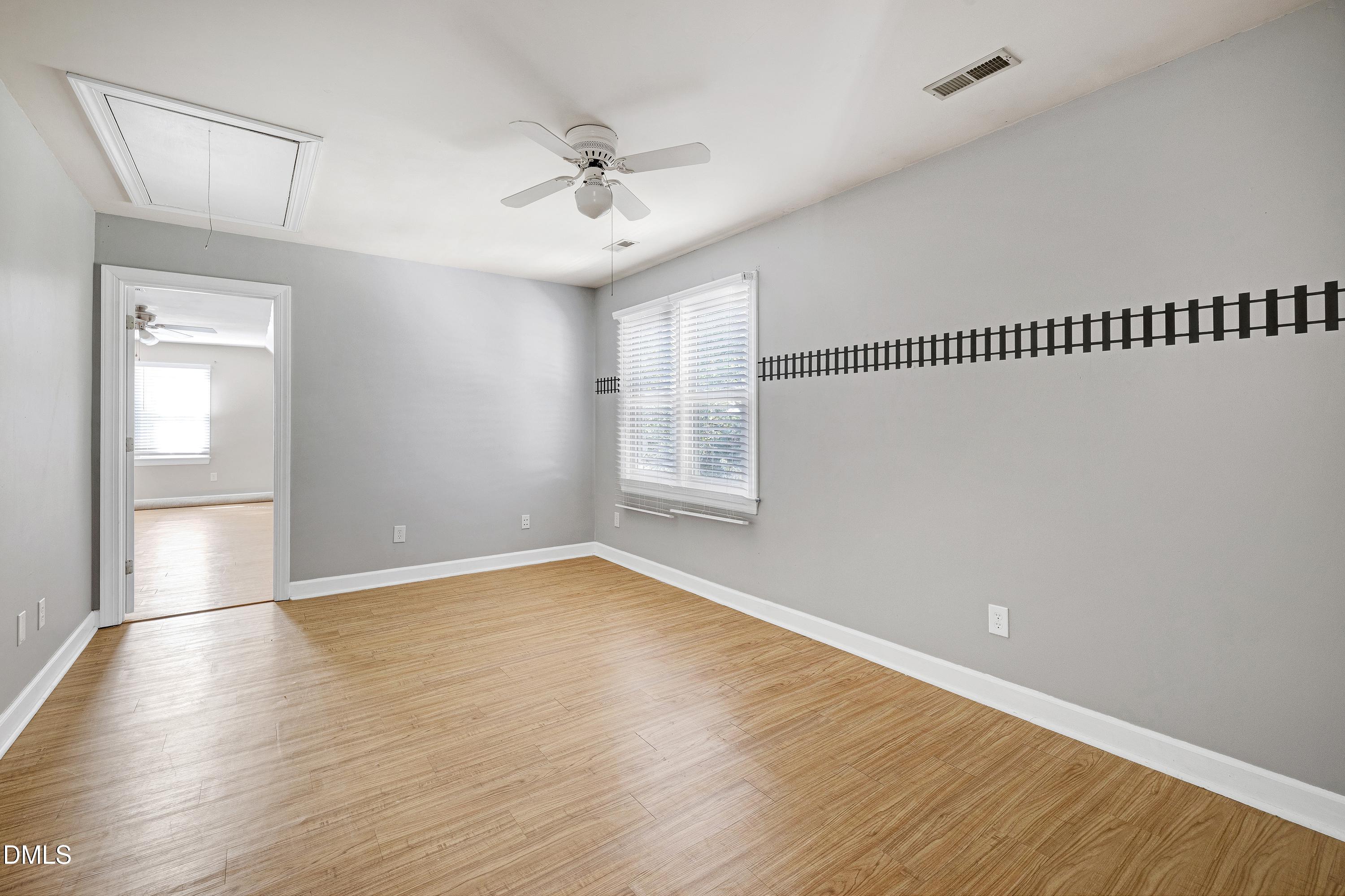 4804 Sinclair Drive Raleigh, NC 27616 - Photo 25 of 37 a view of an empty room with wooden floor and a window