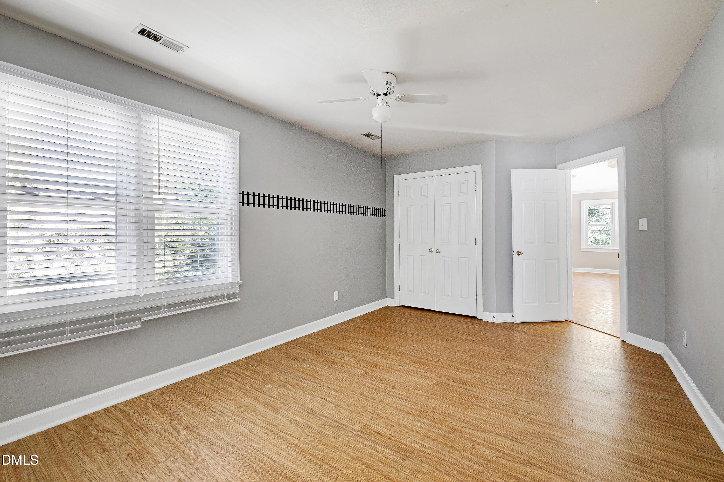 4804 Sinclair Drive Raleigh, NC 27616 - Photo 26 of 37 a view of an empty room with wooden floor and a window