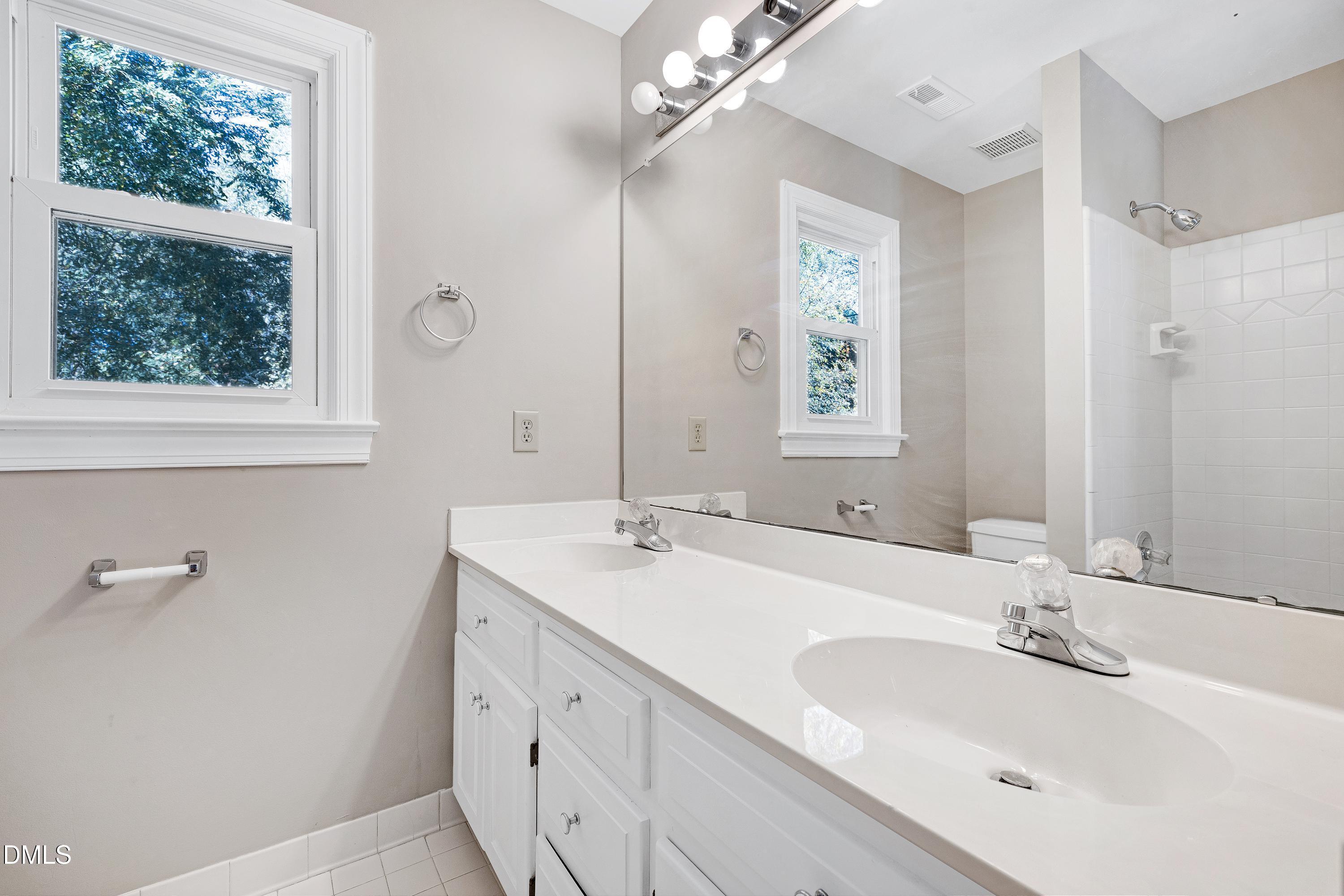 4804 Sinclair Drive Raleigh, NC 27616 - Photo 29 of 37 a bathroom with a double vanity sink and a mirror