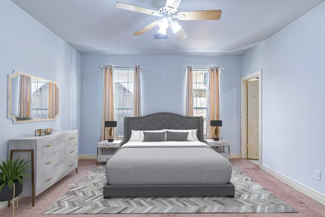 a bedroom with a large bed and a chandelier