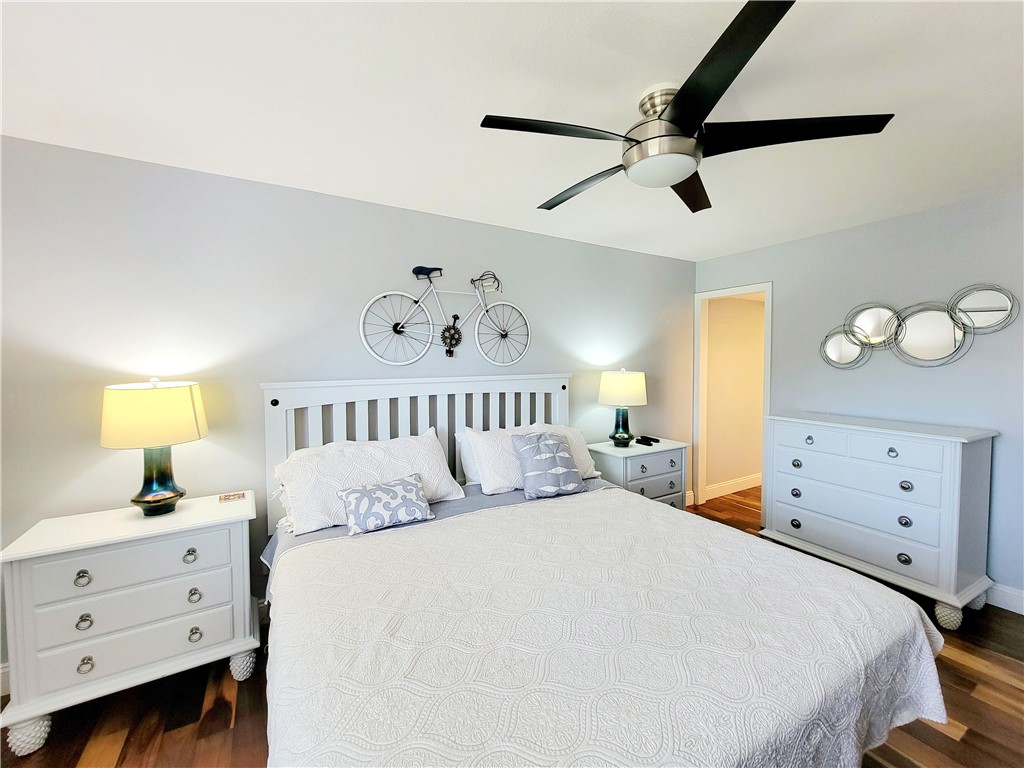 4450 Florida A1A, Unit 303 Vero Beach, FL 32963 - Photo 14 of 24 a bedroom with a large bed and a chandelier