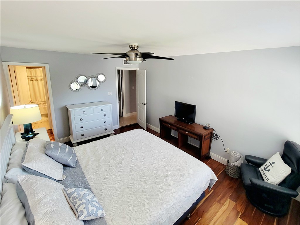 4450 Florida A1A, Unit 303 Vero Beach, FL 32963 - Photo 16 of 24 a bedroom with a bed and a tv