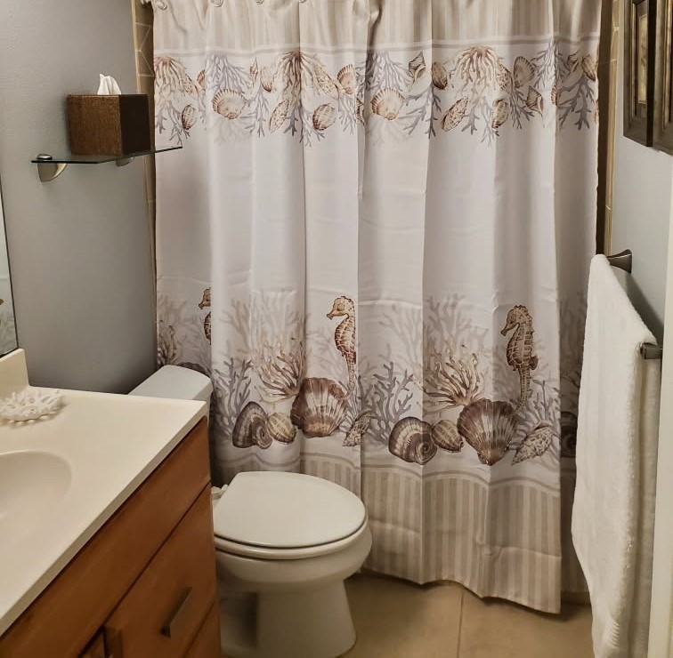 4450 Florida A1A, Unit 303 Vero Beach, FL 32963 - Photo 19 of 24 a bathroom with a sink toilet and shower