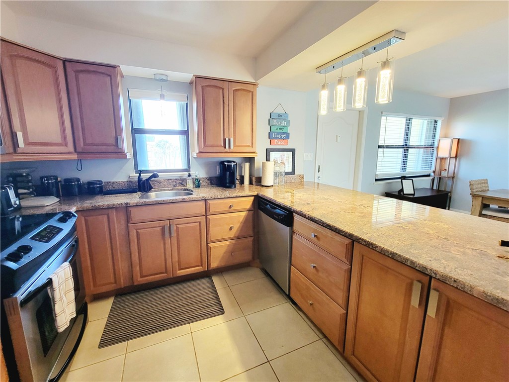 4450 Florida A1A, Unit 303 Vero Beach, FL 32963 - Photo 5 of 24 a kitchen with a sink stove and cabinets