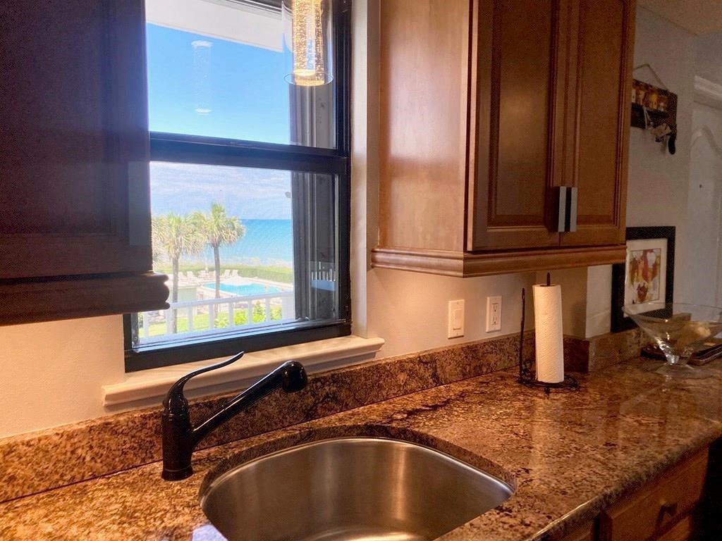 4450 Florida A1A, Unit 303 Vero Beach, FL 32963 - Photo 7 of 24 a kitchen with a sink and a window