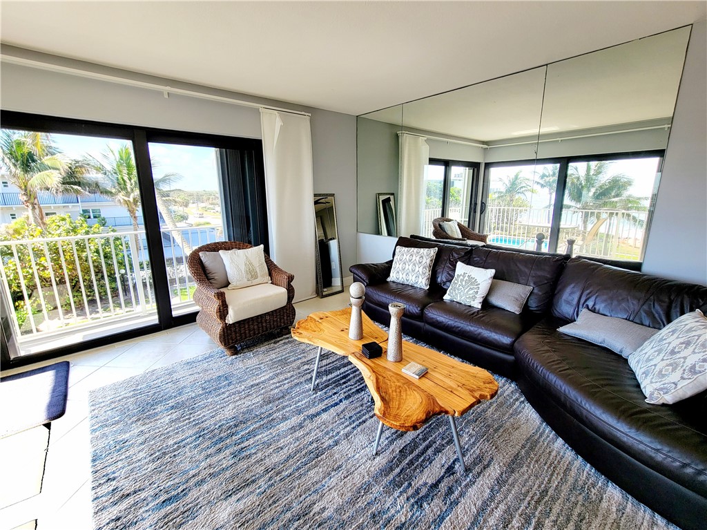 4450 Florida A1A, Unit 303 Vero Beach, FL 32963 - Photo 9 of 24 a living room with furniture and a large window