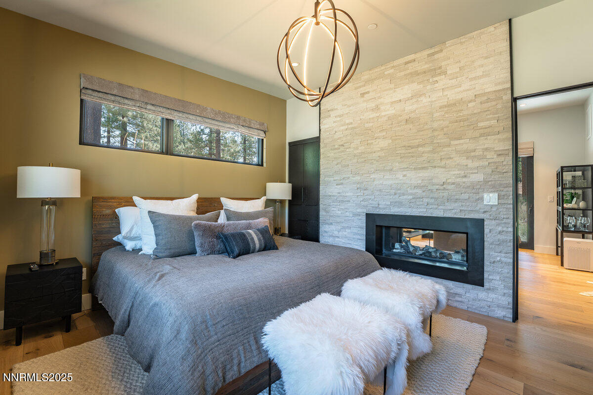 181 Redding Way Carson City, NV 89705 - Photo 35 of 40 a bed room with a bed and a fireplace
