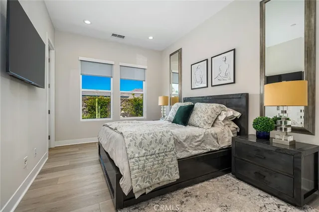 a bed sitting in a bedroom next to a window