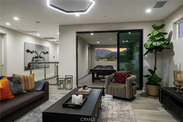 a living room with furniture and a potted plant